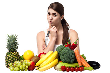 Image showing Mischievous look of a young woman with fruits