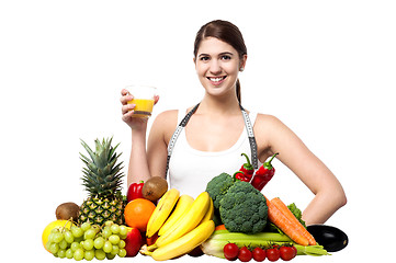 Image showing Young woman with fruits and glass of juice