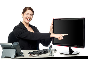 Image showing Lady pointing something on computer screen