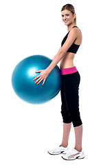 Image showing Female fitness trainer holding swiss ball