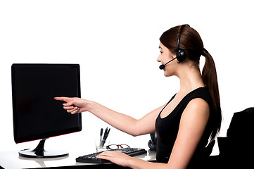 Image showing Female executive pointing at computer screen