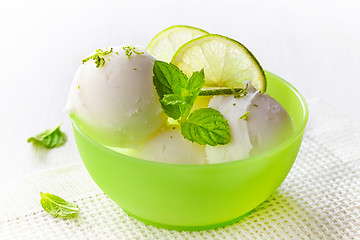 Image showing lemon sorbet decorated with lime slices and mint