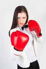 Image showing young businesswoman in boxing gloves