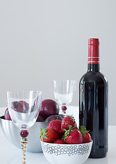 Image showing Red wine, plums and strawberries