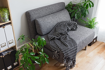 Image showing Living room with bright plants and gray armchair