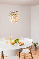 Image showing Decorative chandelier and elegant table with white wine