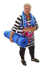 Image showing Female senior with blue gym mat 