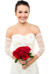 Image showing Gorgeous pretty bride with a rose bouquet