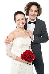 Image showing Excited groom embracing beautiful bride