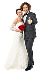 Image showing Groom with his bride showing thumbs up sign