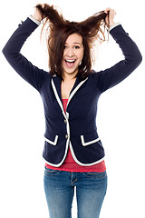 Image showing Young girl pulling her hair in excitement