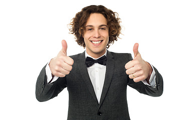 Image showing Joyous young guy gesturing double thumbs up