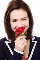 Image showing Lovely young girl with a beautiful red rose