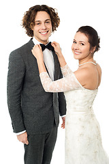 Image showing Pretty bride adjusting her man's bowtie