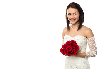 Image showing Pretty bride posing with love red roses bouquet