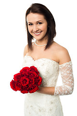 Image showing Smiling bride with a rose bouquet