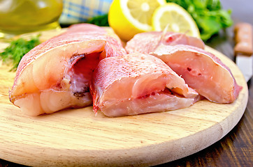 Image showing Fillet of sea bass with oil and a knife