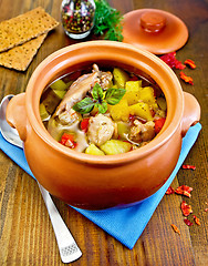 Image showing Roast chicken in a clay pot on a board