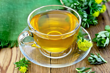 Image showing Herbal tea in a glass cup with Rhodiola rosea on the board