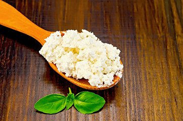 Image showing Curd in a wooden spoon on the board