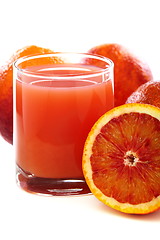 Image showing Glass with juice and blood oranges.