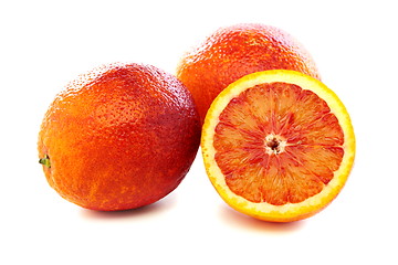 Image showing Full and half of blood red oranges.