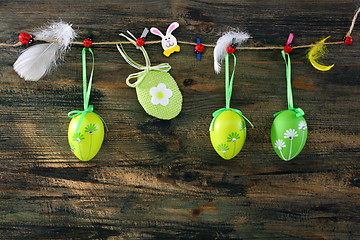Image showing Easter eggs and feathers hanging on a rope.