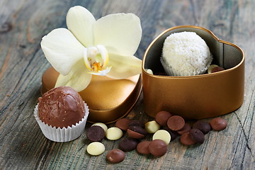 Image showing White Orchid and handmade chocolates.