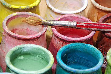 Image showing Old brush and colorful bottles