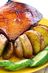 Image showing Pork cucumbers in an orange glaze with roasted potatoes.