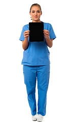 Image showing Pretty doctor showcasing a portable tablet