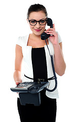 Image showing Bespectacles secretary answering a call