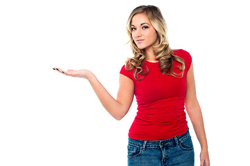 Image showing Casual girl presenting something