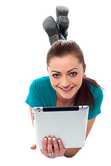 Image showing Pretty girl browsing on her tablet pc