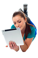 Image showing Relaxed young woman surfing on tablet device