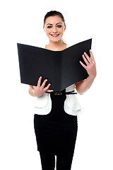 Image showing Fashionable businesswoman reviewing a file