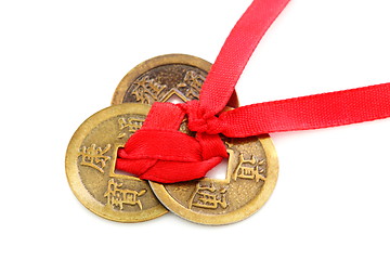 Image showing Three Chinese coins tied with red ribbon.