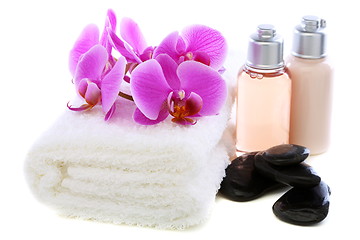 Image showing Set basalt stones, towel and orchid.