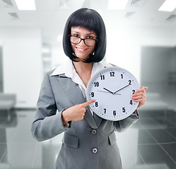 Image showing office worker  holding big clock