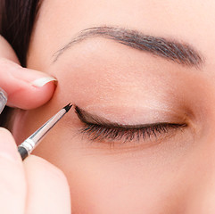 Image showing Beautician artist applying makeup