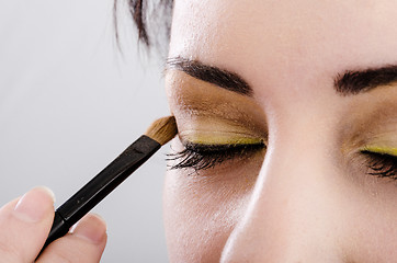 Image showing Beautician artist applying makeup