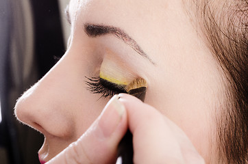 Image showing Beautician artist applying makeup