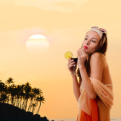 Image showing Caucasian woman drinks unrecognizable cocktail