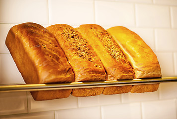 Image showing Freshly kneaded grain and white breads for sale