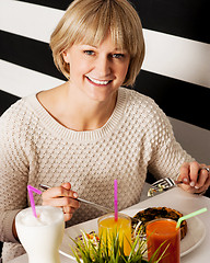 Image showing Beautiful middle aged lady enjoying her meal