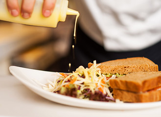 Image showing Mayonnaise sauce poured on a vegetable salad