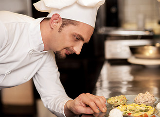 Image showing Satisfied chef analyzing dish before serving