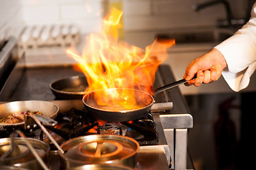 Image showing Chef cooking in kitchen stove