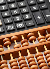 Image showing Ancient abacus and modern calculator