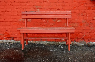 Image showing Red bench and brick wall